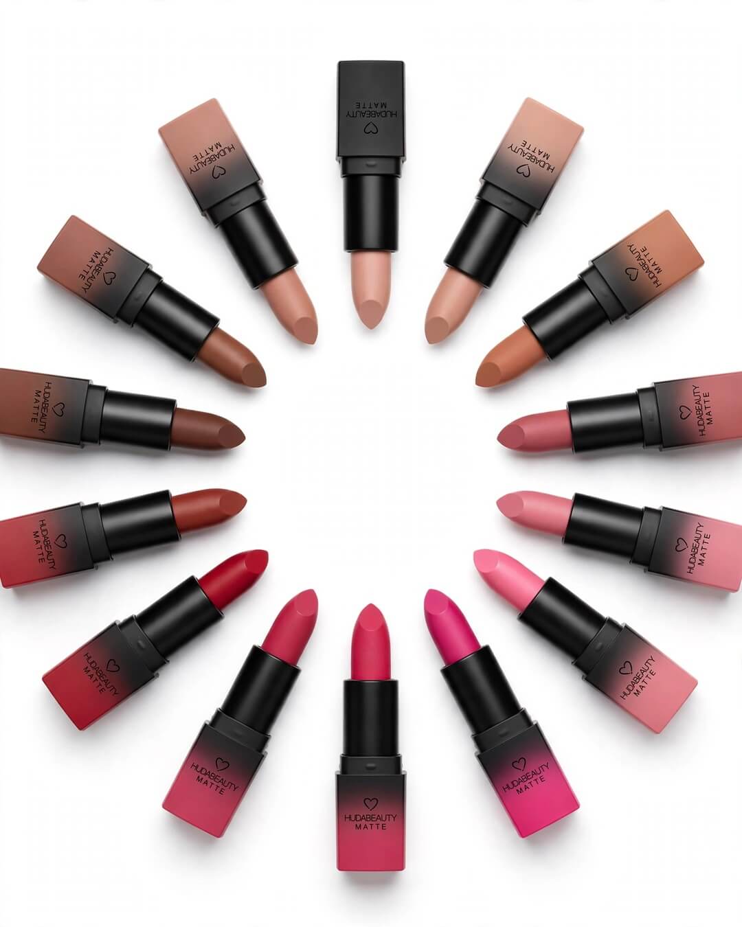 Huda Beauty Matte Lipstick 12 Pcs circle arrangement showing all 12 bullet shades from nude beige brown to bold pink red magenta with heart logo