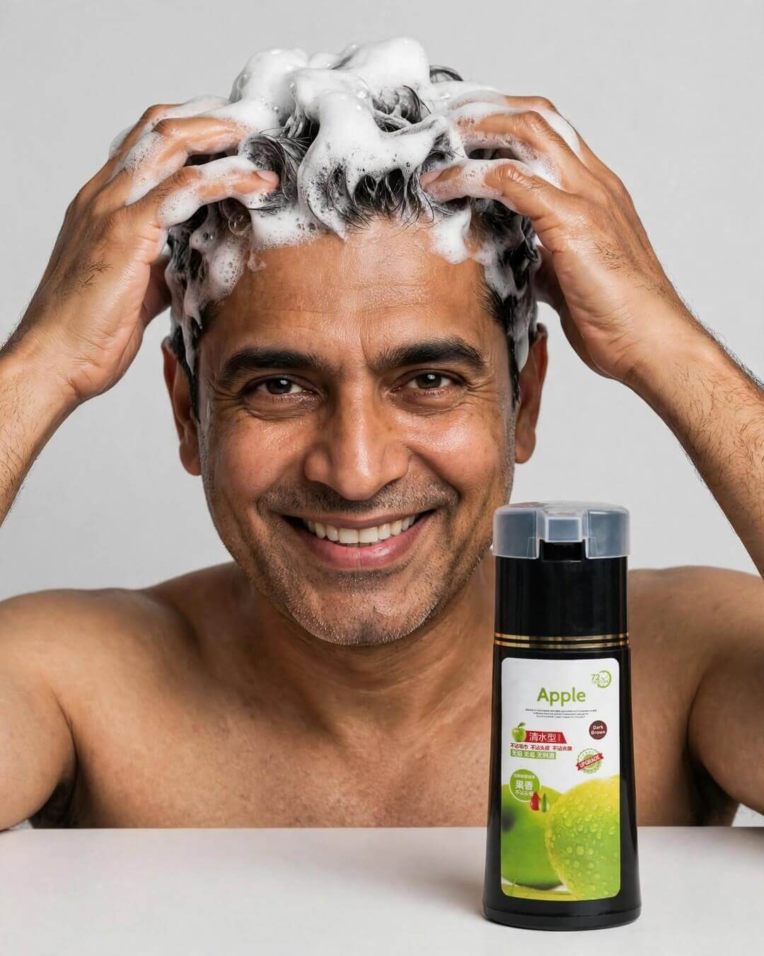 Pakistani man 48 using dark brown beard hair dye shampoo Apple 200ml with white lather foam shoulders only, looking at camera, 3 in 1 grey coverage ammonia free Pakistan